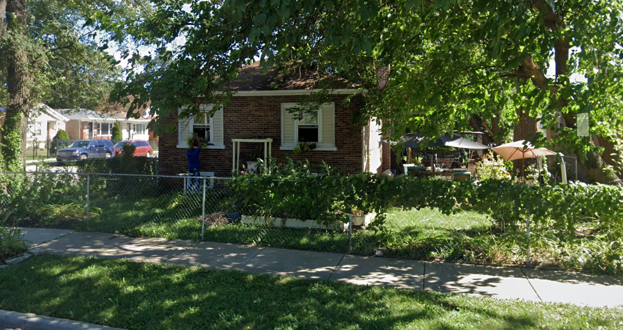 Small brick house with a garden in a residential area